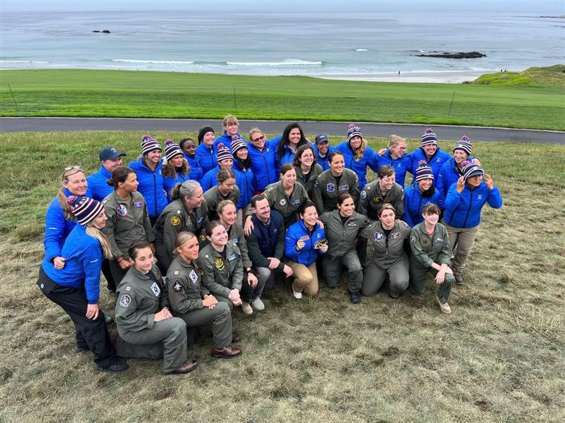 A large group of women posing for a group photo outside