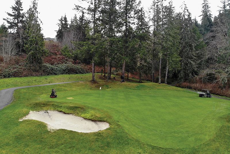 Crew members working outdoors on a golf course